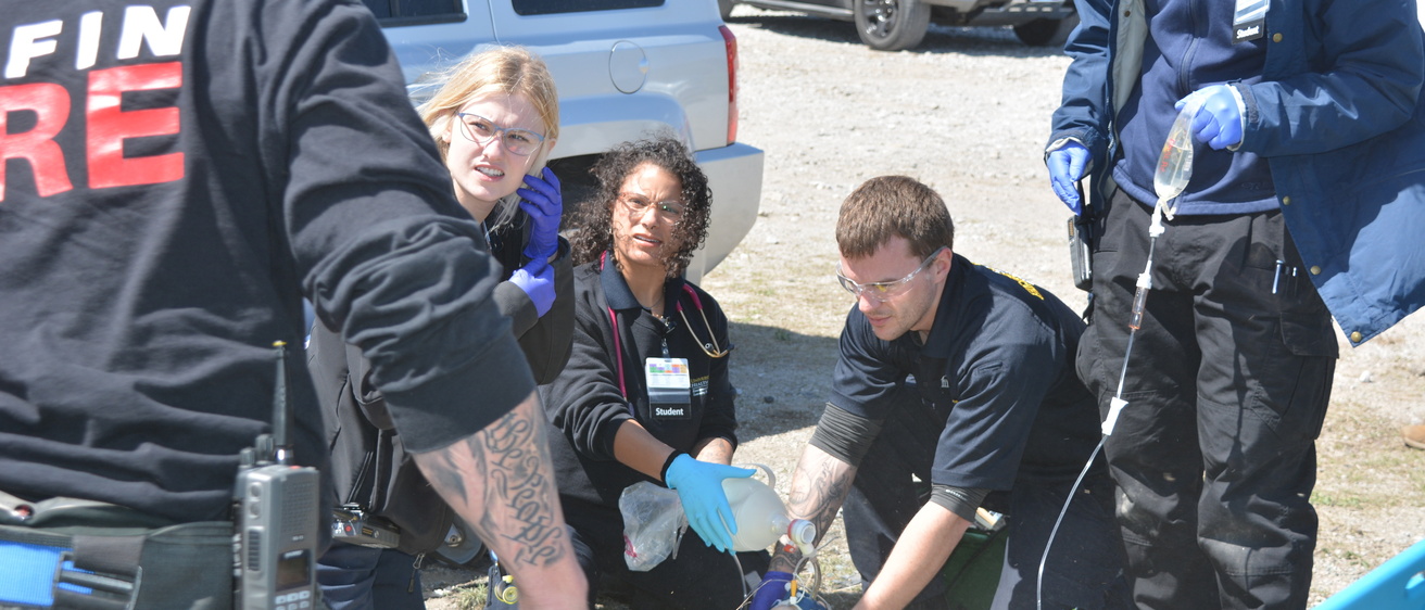 Paramedic students treating a simulated patient